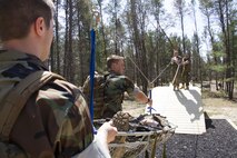 Marine Corps Officer candidates and applicants work together to complete a Leadership Reaction Course at Fort McCoy, Wis., May 2, 2015.  Recruiting Stations Milwaukee and Twin Cities conducted a joint weekend event to prepare the candidates for Officer Candidates School.  