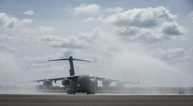 A C-17 Globemaster III assigned to the 437th Airlift Wing and the 315th Airlift Wing is sprayed with water May 5, 2015, at Joint Base Charleston, S.C., during an event celebrating the C-17 surpassing the 3 millionth flying hour. Aircrew members from Charleston flew the plane from Robins Air Force Base, Ga. The first C-17 flight was Sept. 15, 1991, and the Air Force currently has 222 C-17s in the fleet. (U.S. Air Force photo/Senior Airman Jared Trimarchi) 