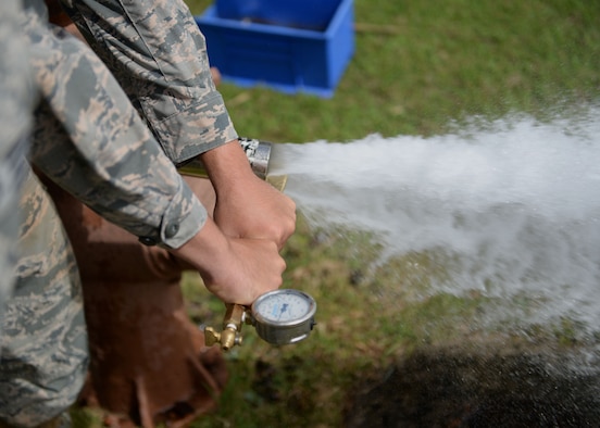 Senior Airman Brad Stevens, a 36th Civil Engineer Squadron water and fuels systems journeyman, performs a fire hydrant flow test April 30, 2015, at Andersen Air Force Base, Guam. Water and fuels systems maintainers also repair, maintain or replace washers, valve seats, leaking faucets, and interior or exterior water and sewer lines. (U.S. Air Force photo/Airman 1st Class Joshua Smoot)