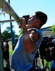 Staff Sgt. Jeoffrey Ilgenfritz, 1st Special Operations Component Maintenance Squadron hydraulics systems craftsman, does pull ups for Hurlburt Field’s fitness day at Hurlburt Field, Fla., May 6, 2015. Air Force Fitness Month promotes physical wellness and teaches Airmen how being "fit" plays a vital role in the quality of military life. (U.S. Air Force photo/Airman 1st Class Andrea Posey)