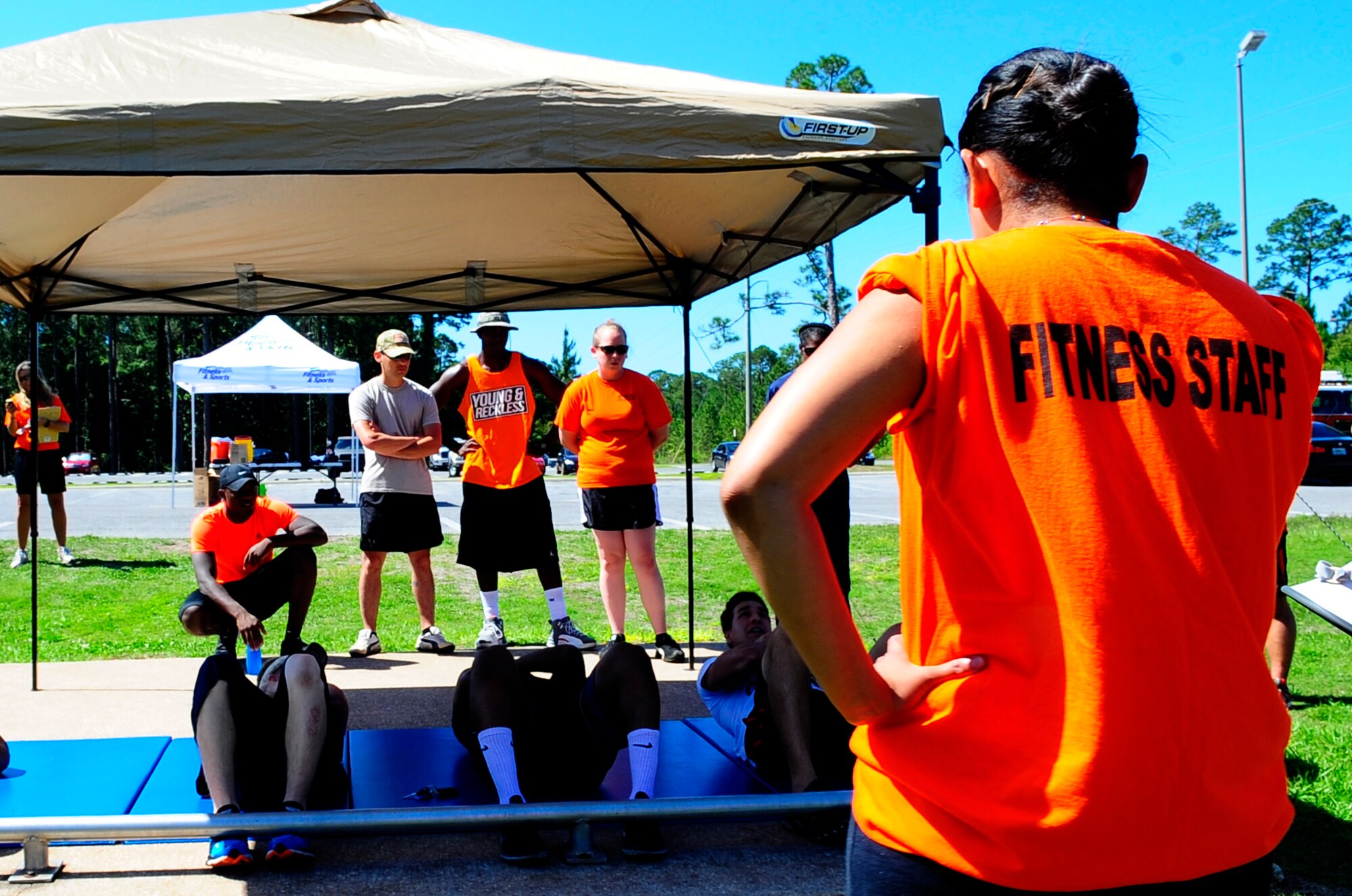 Senior Airman Veronica Sanchez, 1st Special Operations Force Support Squadron fitness specialist, times Air Commandos during a sit-up competition at Hurlburt Field, Fla., May 6, 2015. Air Force Fitness Month promotes physical wellness and teaches Airmen how being "fit" plays a vital role in the quality of military life. (U.S. Air Force photo/Airman 1st Class Andrea Posey)