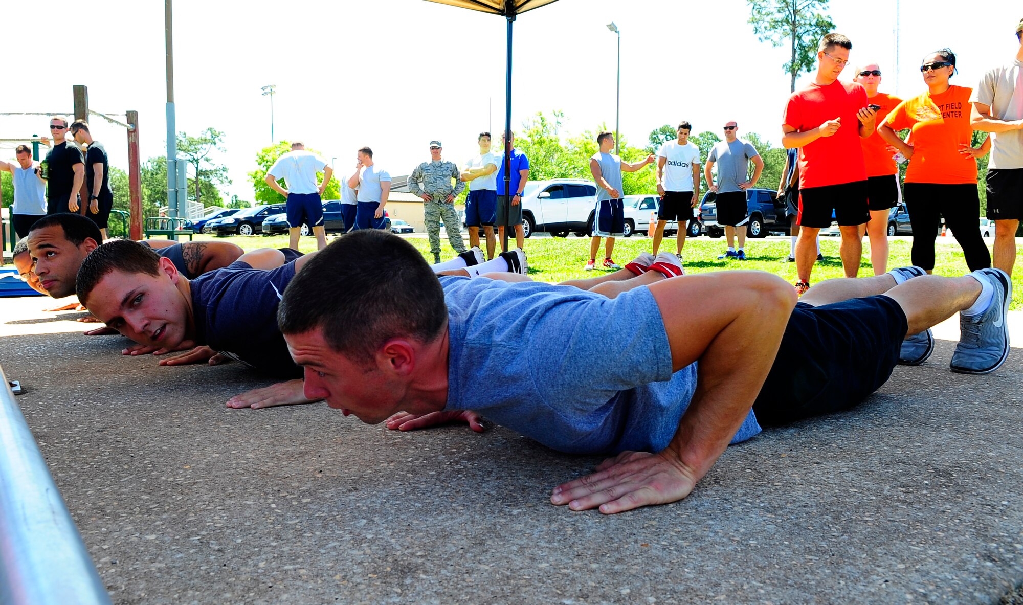 Air Commandos prepare to perform push-ups during a push-up competition at Hurlburt Field, Fla., May 6, 2015. Air Force Fitness month promotes physical wellness and teaches Airmen how being "fit" plays a vital role in the quality of military life. (U.S. Air Force photo/Airman 1st Class Andrea Posey)