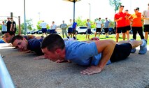 Air Commandos prepare to perform push-ups during a push-up competition at Hurlburt Field, Fla., May 6, 2015. Air Force Fitness month promotes physical wellness and teaches Airmen how being "fit" plays a vital role in the quality of military life. (U.S. Air Force photo/Airman 1st Class Andrea Posey)
