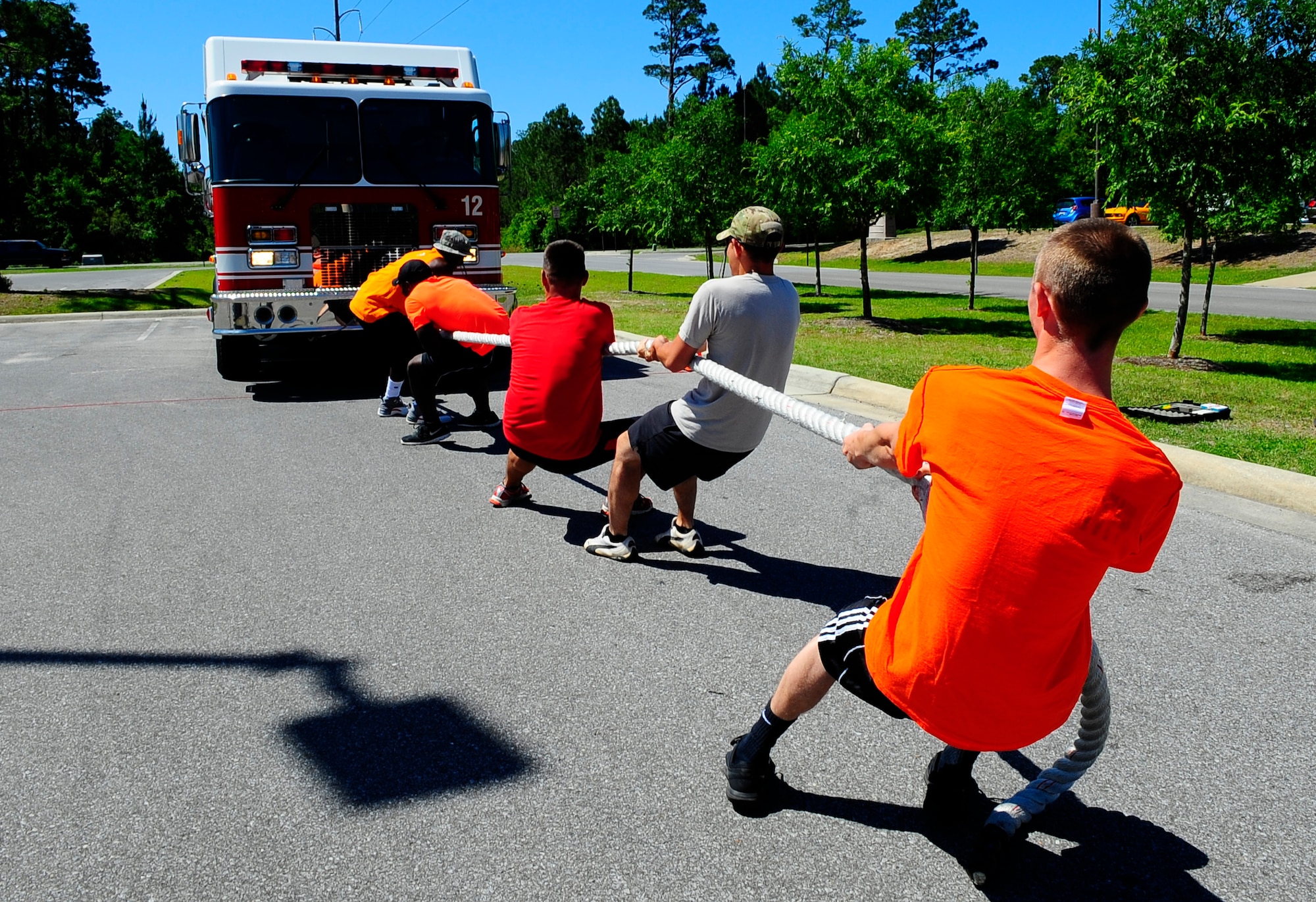 The 1st Special Operations Force Support Squadron team works together to pull a fire truck for fitness day at Hurlburt Field, Fla., May 6, 2015. Air Force Fitness Month promotes physical wellness and teaches Airmen how being "fit" plays a vital role in the quality of military life. (U.S. Air Force photo/Airman 1st Class Andrea Posey)