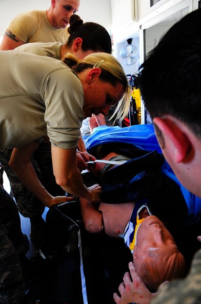 Air Commandos from the 1st Special Operations Medical Operations Squadron check a simulated crash victim in an ambulance at Hurlburt Field, Fla., May 6, 2015. The medical group promotes and maintains the health of approximately 8,900 base personnel to ensure a vital and fit force, deployable to any location. (U.S. Air Force photo/Airman 1st Class Andrea Posey)