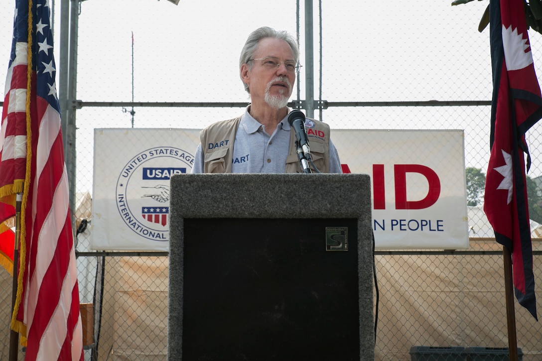 U.S. Agency for International Development’s Disaster Assistance Response Team Leader, Bill Berger, updates international donors of the U.S. relief operations in Kathmandu, Nepal. Berger gave his remarks on how the U.S. government relief assistance is coordinated, the role of the Disaster Assistance Response Team, and a summary of USAID’s response. “USAID is the lead U.S. federal agency responding to disasters overseas,” said Berger. “We have the ability to tap any resource within the U.S. government that we need to bring. So, in this instance the first thing we did was get our search and rescue people here. We had two 57-man, six-dog teams who immediately jumped on military lift and got out here within 72 hours and began search and rescue.” U.S. military members along with USAID and search and rescue teams from the Los Angeles Fire Department and Fairfax County, Virginia, came to the aid of Nepal after a 7.8 magnitude earthquake struck April 25.