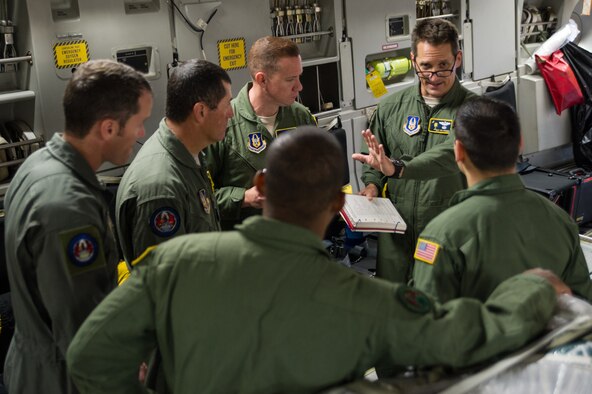 Master Sgt. Ken Hundemer discusses security operations, April 23, 2015 with members of the 315th Security Forces Squadron while on a training mission to Haiti during a four-day training mission to Key West Naval Air Station, Fla. The 315th Airlift Wing flew 20 sorties during the four-day deployment and airlifted more than 345,000 pounds of humanitarian cargo, which included 61 pallets of food and clothing and one school bus. Hundemer is a loadmaster assigned to the 317th Airlift Squadron, and he also serves as the Denton Program director of operations in his civilian capacity. (U.S. Air Force Photo by Tech. Sgt. Shane Ellis)