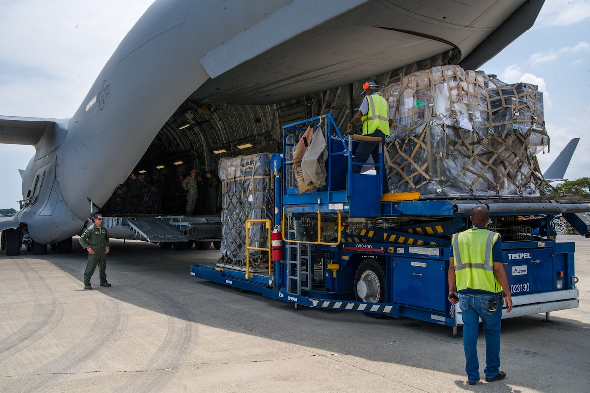 Chief Master Sgt. Rob Grimsley, 315th Security Forces Squadron Raven, monitors the movement of personnel offloading Denton cargo from a C-17 Globemaster III April 24, 2015 in Haiti during a four-day training mission to Key West Naval Air Station, Fla. The 315th Airlift Wing flew 20 sorties during the four-day deployment and airlifted more than 345,000 pounds of humanitarian cargo, which included 61 pallets of food and clothing and one school bus. (U.S. Air Force Photo by Tech. Sgt. Shane Ellis)
