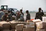 KATHMANDU, Nepal (May 7, 2015) - U.S. Airmen and Nepalese service members dismount a pallet of humanitarian aid after an aircraft offload during Joint Task Force 505 humanitarian assistance and disaster relief at Tribhuvan International Airport. The Nepalese government requested the U.S. government's assistance after a 7.8 magnitude earthquake struck the country April 25. U.S Marines from III Marine Expeditionary Force came together with other services to provide unique capabilities to assist Nepal. 