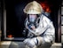 Tech Sgt. Aaron Bebernitz, 315th Civil Engineering Flight fire prevention operations chief, gives visual confirmation of rollover fire prior to extinguishing it during routine training May 2, 2015, at Joint Base Charleston, S.C. After multiple dry runs, the proficiency training of live structural fires is conducted twice a year and tests the firefighters ability to extinguish flames. (U.S. Air Force photo / Senior Airman Tom Brading)