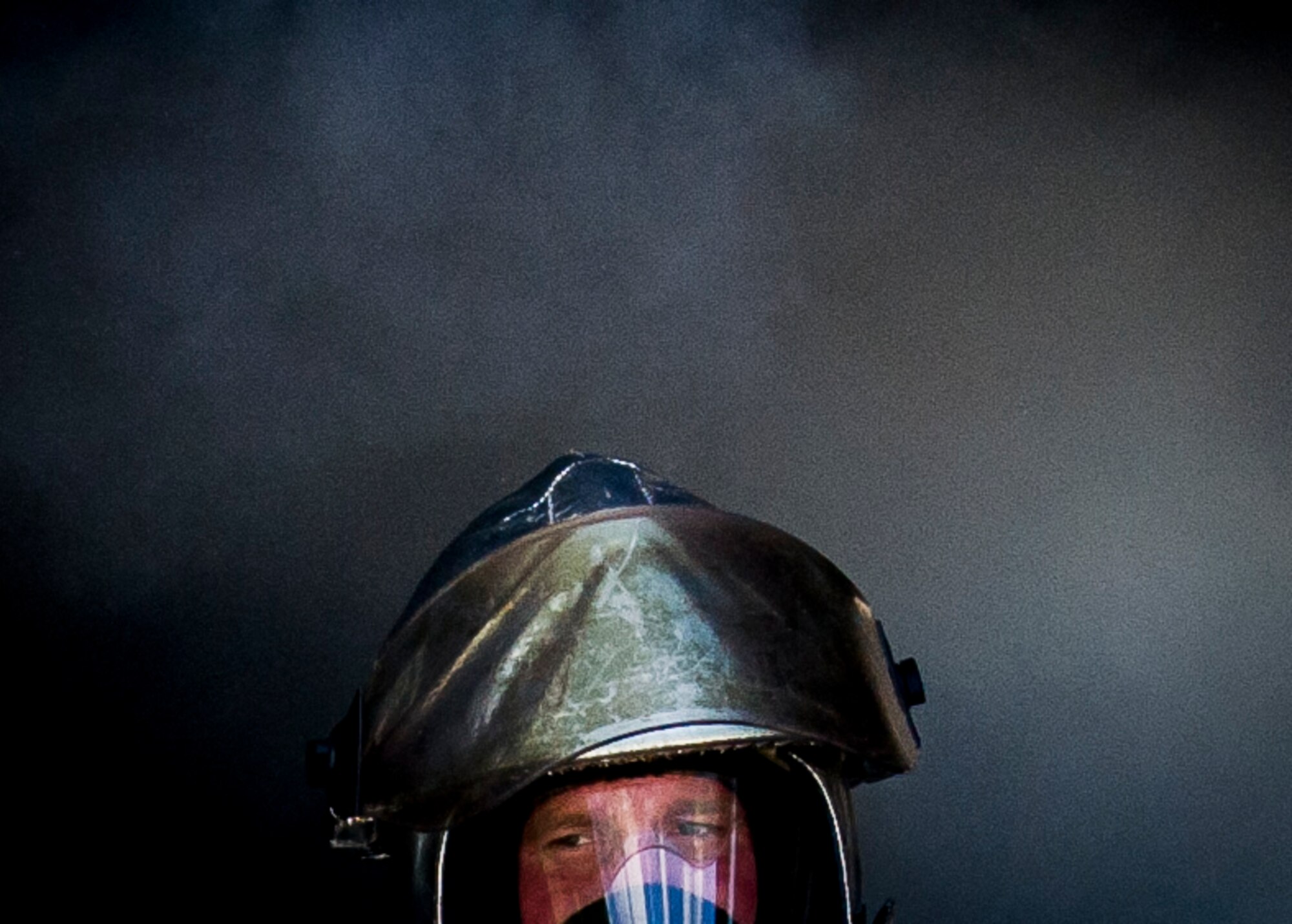Staff Sgt. Chad Blackburn, 315th Civil Engineering Flight firefighter, exits the structure fire training building upon completing routine training May 2, 2015, at Joint Base Charleston, S.C. After multiple dry runs, the proficiency training of live structural fires is conducted twice a year and tests the firefighters ability to extinguish flames. (U.S. Air Force photo / Senior Airman Tom Brading)