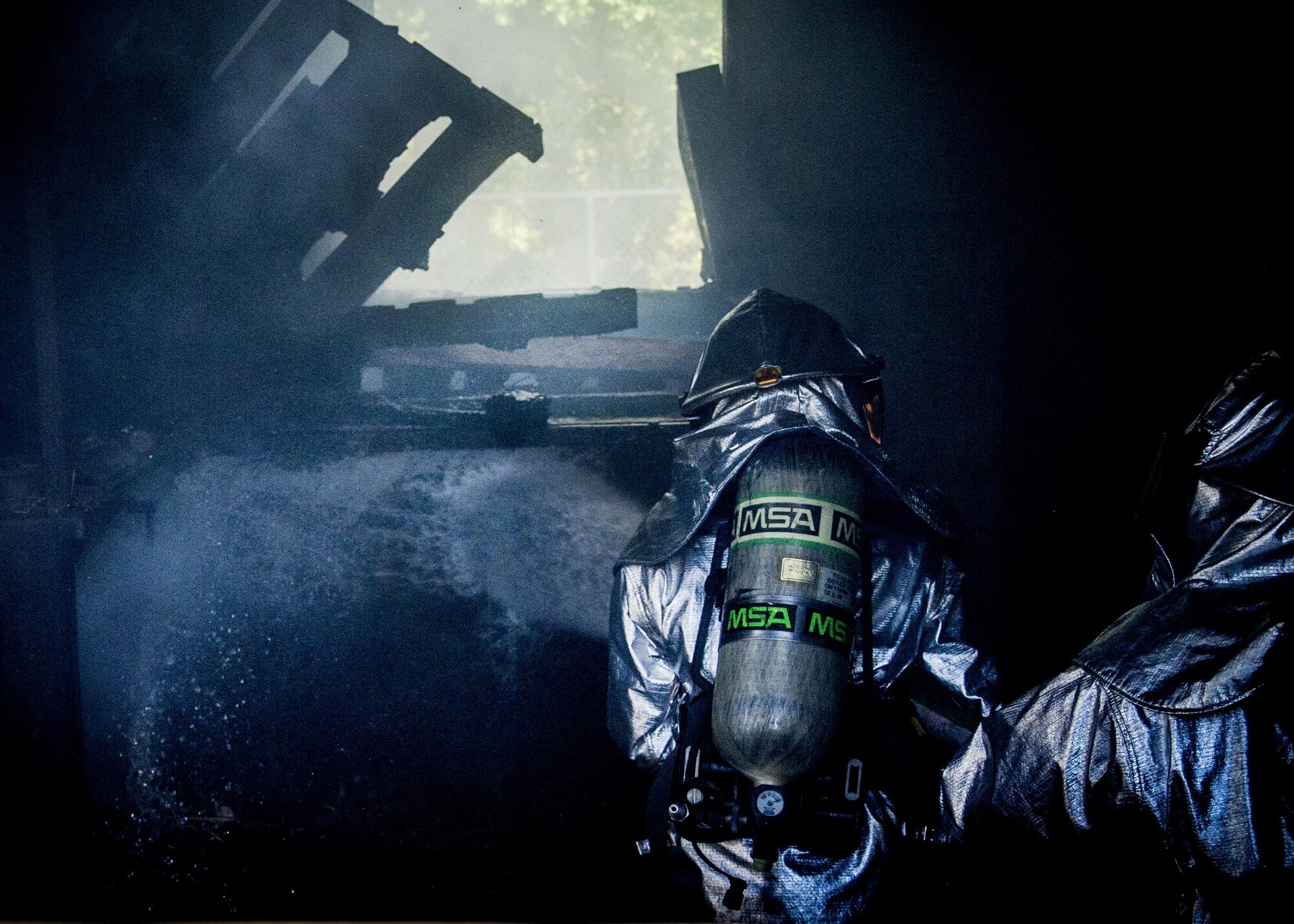 Firefighters assigned to the 315th Civil Engineering Flight put the finishing touches on a structure fire May 2, 2015, at Joint Base Charleston, S.C. After multiple dry runs, the proficiency training of live structural fires is conducted twice a year and tests the firefighters ability to extinguish flames. (U.S. Air Force photo / Senior Airman Tom Brading)