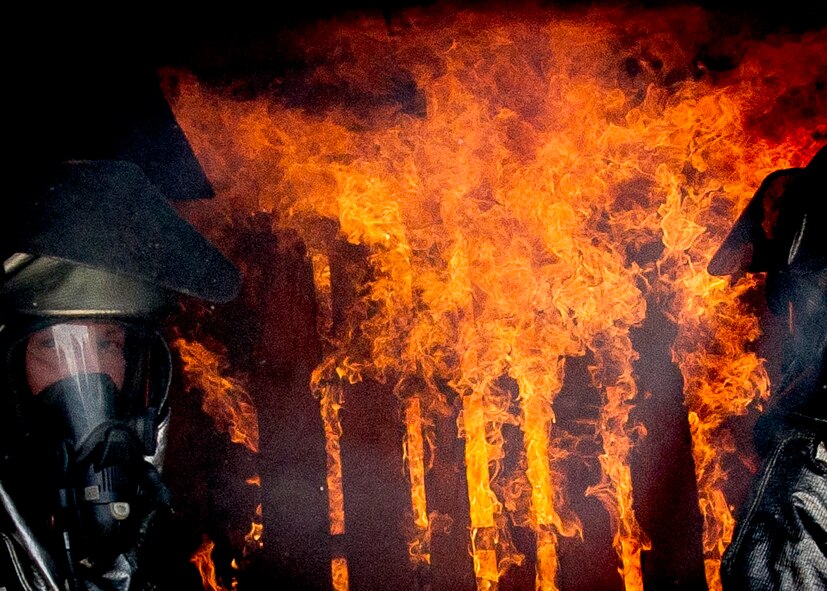 Firefighters assigned to the 315th Civil Engineering Flight conduct training May 2, 2015, at Joint Base Charleston – Air Base, S.C. The flight line training was done with a dry hose and tested the members' response time and ability to rescue crew members in the event of an emergency. (U.S. Air Force photo / Senior Airman Tom Brading) 