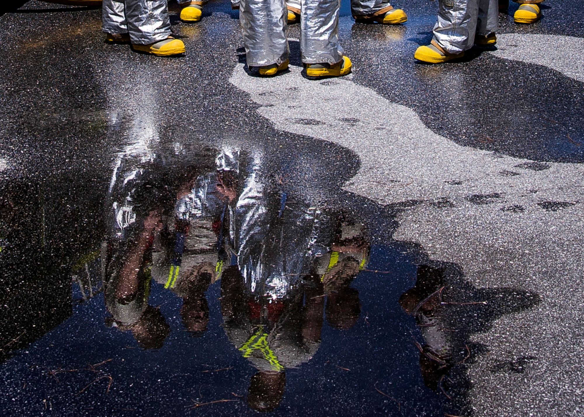 Firefighters assigned to the 315th Civil Engineering Flight prepare to conduct training May 2, 2015, at Joint Base Charleston – Air Base, S.C. The flight line training was done with a dry hose and tested the members response time and ability to rescue crew members in the event of an emergency. (U.S. Air Force photo / Senior Airman Tom Brading)
