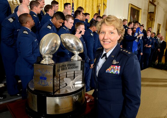 Lt. Gen. Michelle D. Johnson, the superintendent of the U.S. Air Force Academy, in Colorado Springs, Colo., stands with the Commander-in-Chief's Trophy with some of the Academy football team behind her, at the White House May 7, 2015. President Barack Obama congratulated the team, with Johnson and Air Force Chief of Staff Gen. Mark A. Welsh III present for a ceremony. (U.S. Air Force photo/Scott M. Ash)   