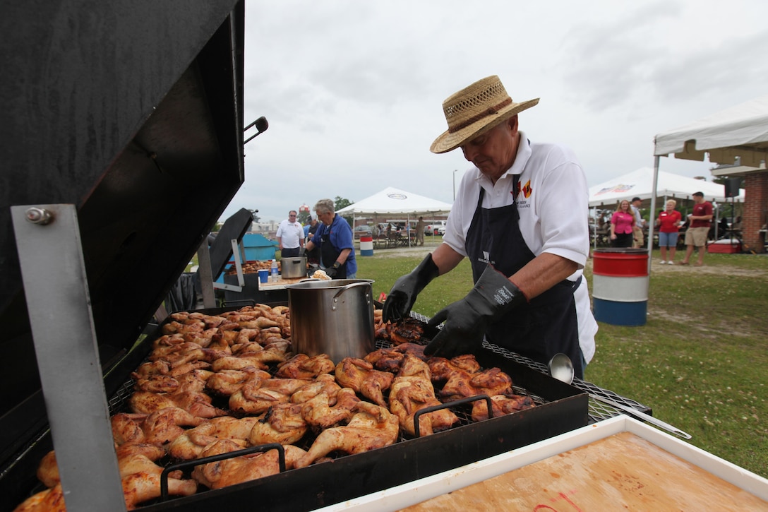 Carl Barwick seasons and grills dozens of chickens during the New Bern Military Alliance Spring Chicken Pickin’ at Marine Corps Air Station Cherry Point, North Carolina, May 6, 2015. Barwick volunteered for the event through the NBMA.