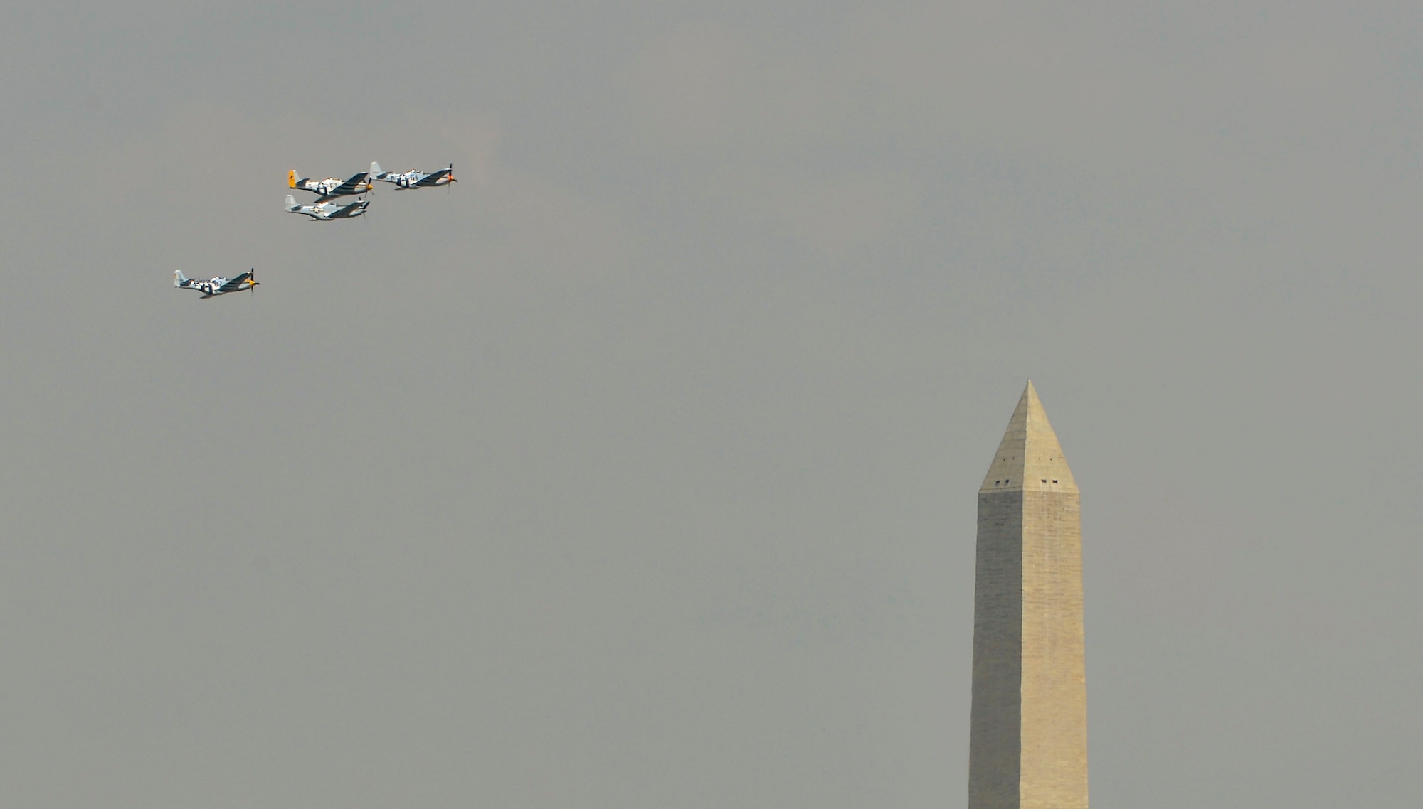 Vintage World War II aircraft fly over the nation's capital as they participate in the Arsenal of Democracy event commemorating the 70th anniversary of V-E Day, May 8, 2015, in Washington, D.C. More than two dozen aircraft participated in the spectacle, which followed a path along the Potomac River and passed over landmarks including the Lincoln Memorial and the Washington Monument. (Defense Department photo/Glenn Fawcett)