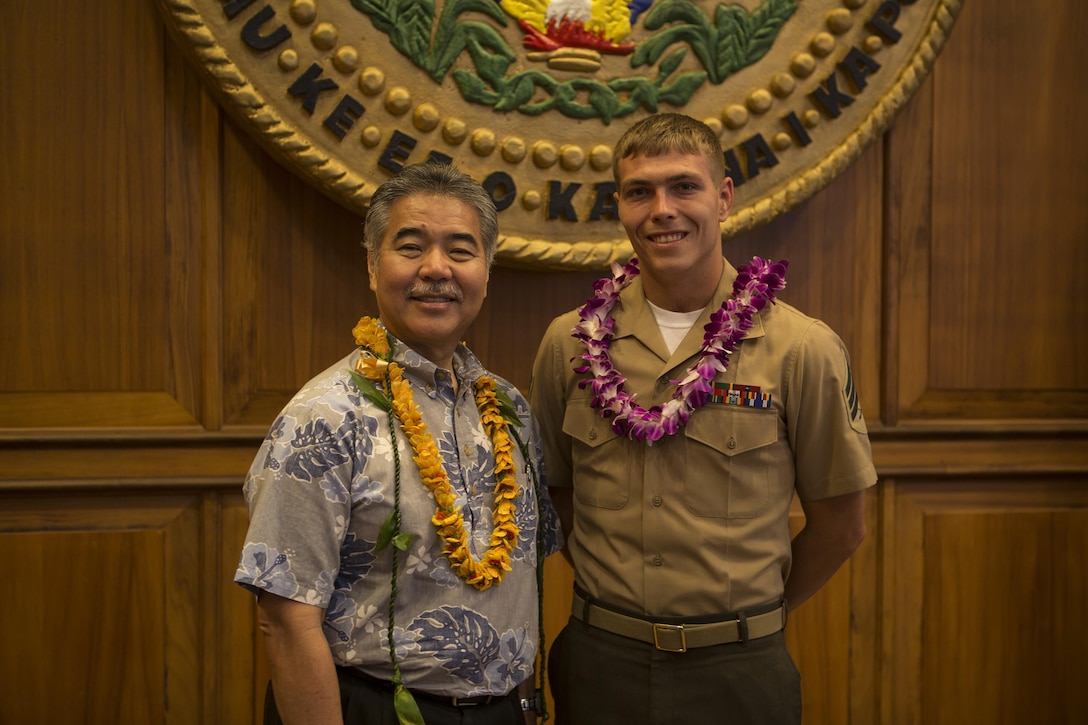 State of Hawai'i Governor David Ige, and Sgt. Jonathon McDonald, a motor transport operator with Headquarters and Service Battalion, U.S. Marine Corps Forces, Pacific pose, for a photo, May 8, 2015 at the Hawai'i State Capitol Building. McDonald was recognized as the Marine Corps' 2015 Outstanding Community Service Honoree for the State of Hawai'i for volunteering during his free time to work with special needs children. (U.S. Marine Corps photo by Cpl. Erik Estrada)