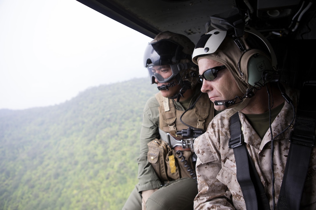 U.S. Marine Corps Sgt. Juan Alcaraz and Maj. Briton Beck, both with Joint Task Force 505, observe areas affected by an earthquake in outlying villages near Kathmandu, Nepal, during an aerial survey flight May 7. The Nepalese government requested the U.S. government’s assistance after a 7.8 magnitude earthquake struck the country April 25. U.S. military services came together to form JTF 505, which works in conjunction with U.S. Agency for International Development and the international community, to provide unique capabilities to assist Nepal.