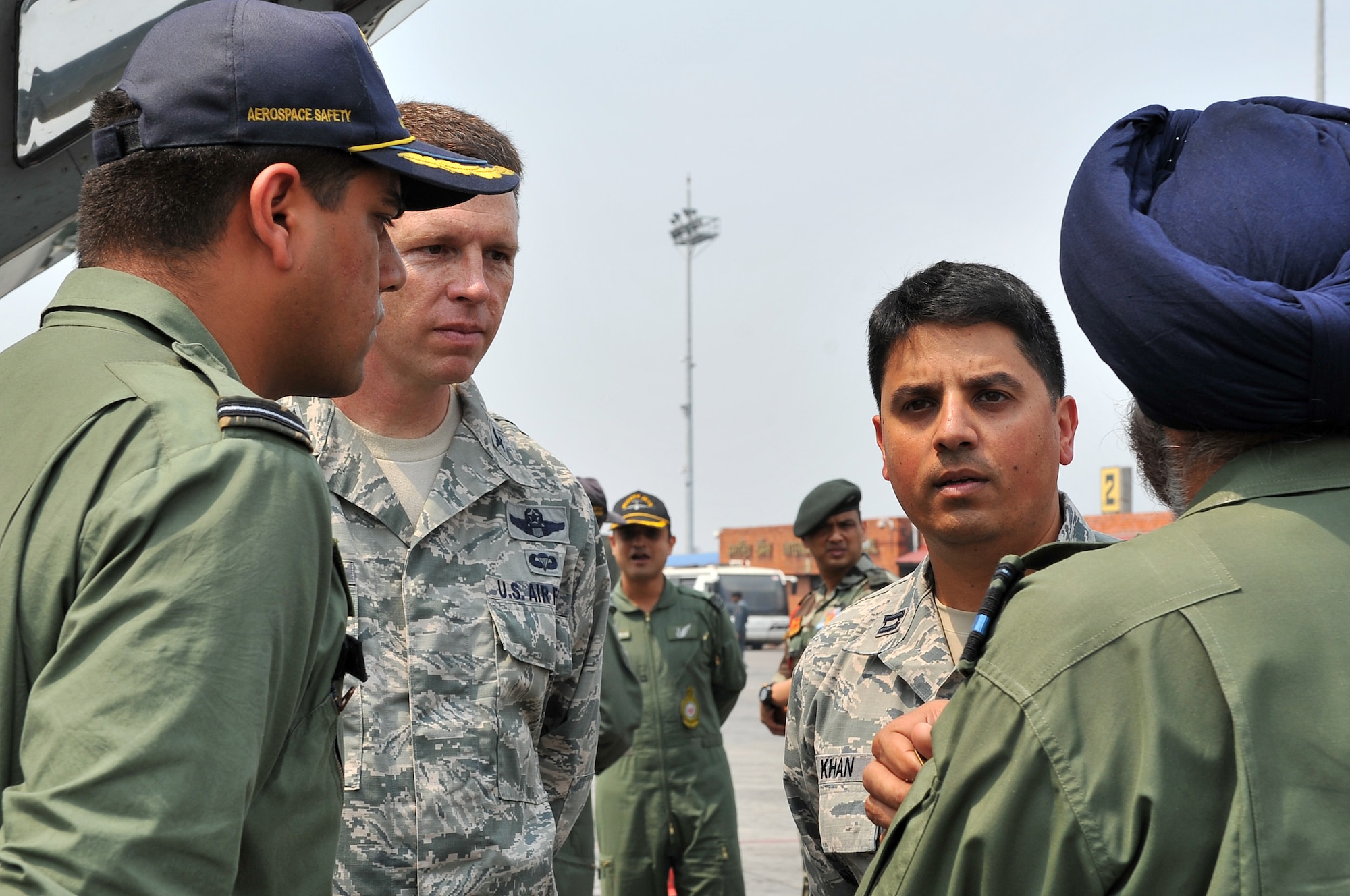 U.S. Air Force Col. Lee Anderson, 36th Contingency Response Group commander, and U.S. Air Force Capt. Asim Khan, Pacific Air Forces South Asia country director, talk with Indian air force leadership after they delivered relief supplies on their IL-76 cargo aircraft May 7, 2015, at the Tribhuvan International Airport in Kathmandu, Nepal. The Nepalese Army and U.S. Air Force Airmen worked with military members from the Bangladesh air force and Indian air force to process cargo from their aircraft arriving in Nepal to provide disaster relief following a magnitude 7.8 earthquake that struck the nation April 25.  (U.S. Air Force photo by Staff Sgt. Melissa White/Released)