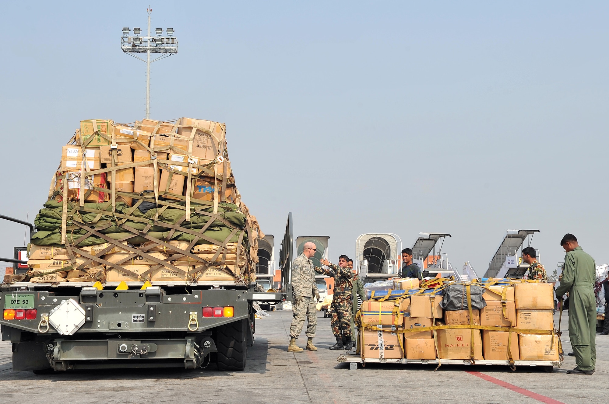 Nepalese Army, 36th Contingency Response Group Airmen, and Bangladesh Air Force members process relief supplies from a BAF C-130 Hercules May 7, 2015, at the Tribhuvan International Airport in Kathmandu, Nepal. The Nepalese Army and Airmen worked with military members from the Bangladesh Air Force and Indian Air Force to process cargo from their aircraft arriving in Nepal to provide disaster relief following a magnitude 7.8 earthquake that struck the nation April 25. (U.S. Air Force photo by Staff Sgt. Melissa White/Released)