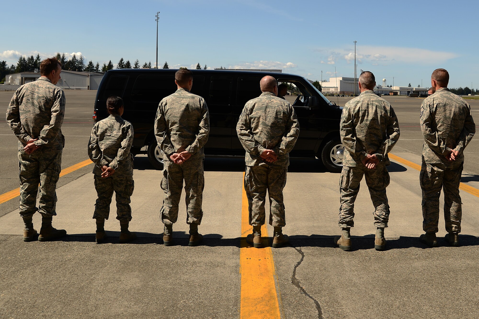Airmen from the 62nd Maintenance Group wait to greet members of the Business Executives for National Security May 7, 2015, at Joint Base Lewis-McChord, Wash. After the BENS members toured a C-17 Globemaster III and learned about the missions it is used for by the 62nd and 446th Airlift Wings they learned about what it takes to maintain a fleet of C-17s. (U.S. Air Force photo\Staff Sgt. Tim Chacon)