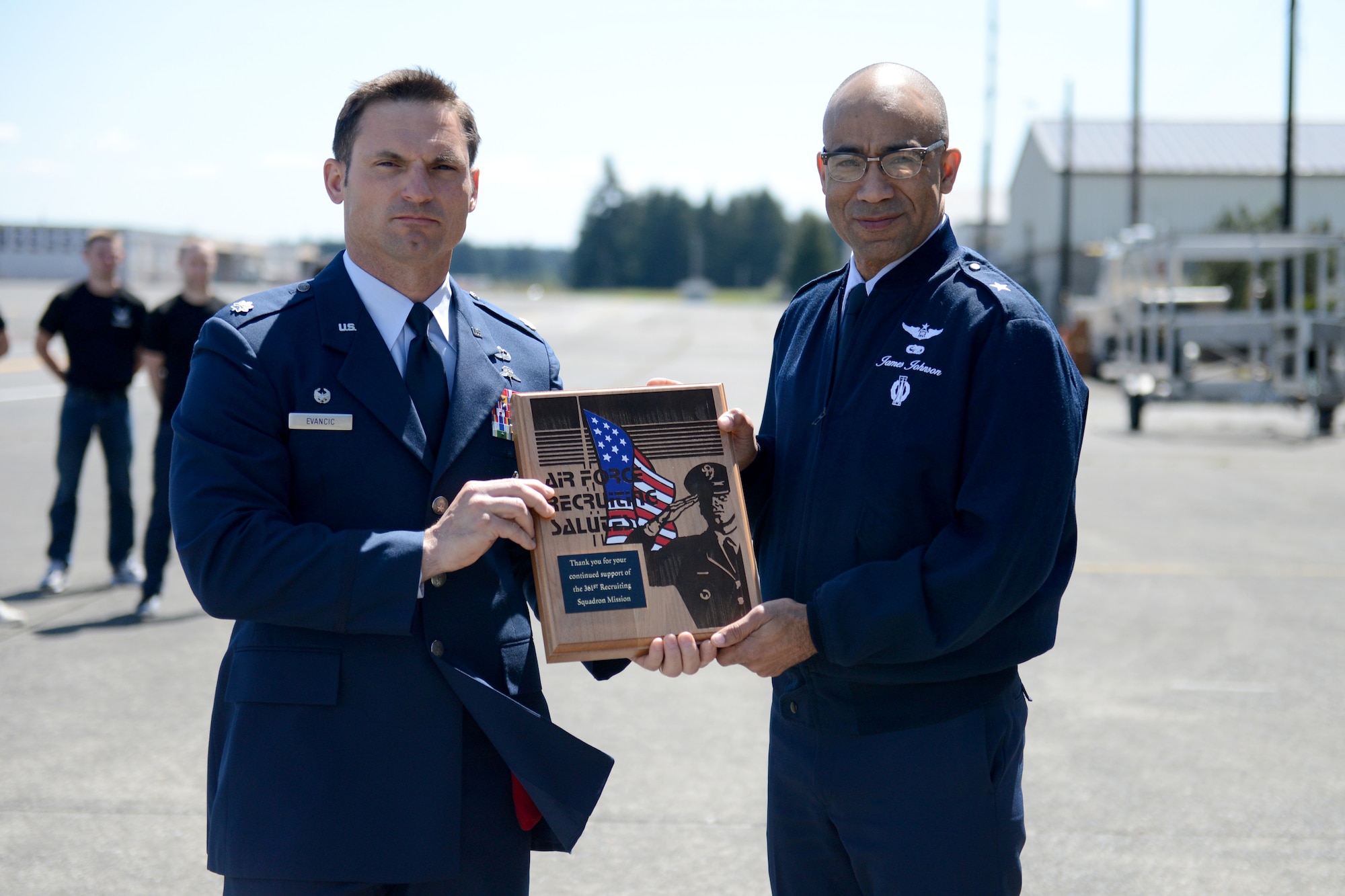 Brig. Gen. James Johnson (right), Air Force Recruiting Service commander, presents Lt. Col. Michael Evancic, 22nd Special Tactics Squadron commander, with the Air Force Recruiting Salutes plaque May 7, 2015, at Joint Base Lewis-McChord, Wash. The Air Force Recruiting Salute plaque is the highest honor the AFRS can give and is in recognition of the 22nd STS’s ongoing support of recruitment. (U.S. Air Force photo/Airman 1st Class Keoni Chavarria)