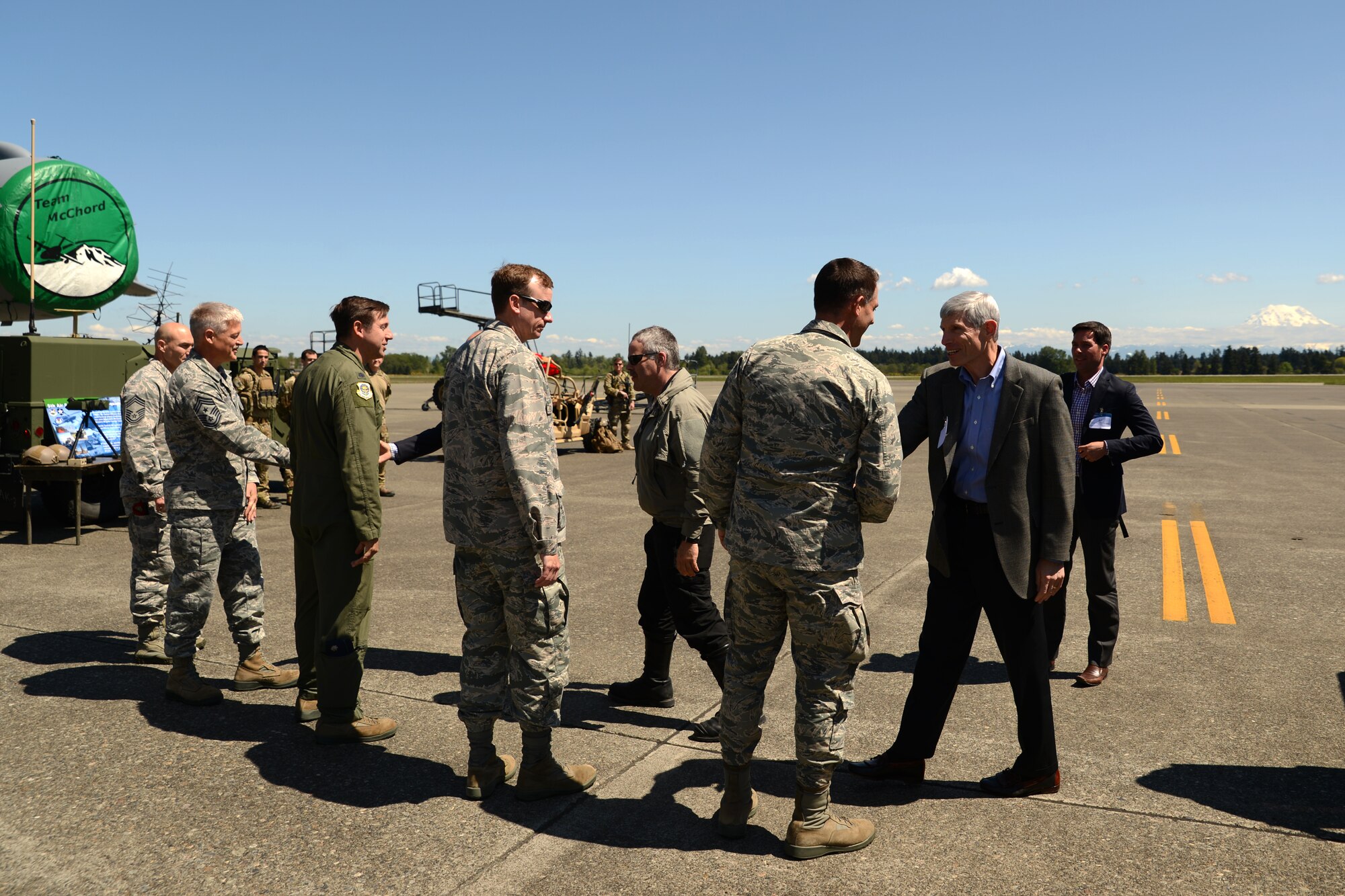 Retired Gen. Norton A. Schwartz, former Air Force chief of staff, watches fellow Business Executives for National Security members climb aboard a C-17 Globemaster III May 7, 2015, at Joint Base Lewis-McChord, Wash. For more than thirty years, BENS has served as a channel through which senior American business leaders can contribute special experience and talent to help build a more secure nation. (U.S. Air Force photo\Staff Sgt. Tim Chacon)
