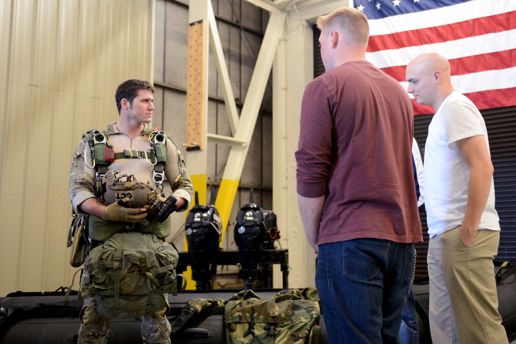 Senior Airman Derek Brown, 22nd Special Tactics Squadron combat controller, shows delayed entry program candidates combat controller equipment May 7, 2015, at Joint Base Lewis-McChord, Wash. After their initial briefing, candidates were able to meet with the Airmen of the 22nd STS and talk to them about their experiences. (U.S. Air Force photo/Airman 1st Class Keoni Chavarria)