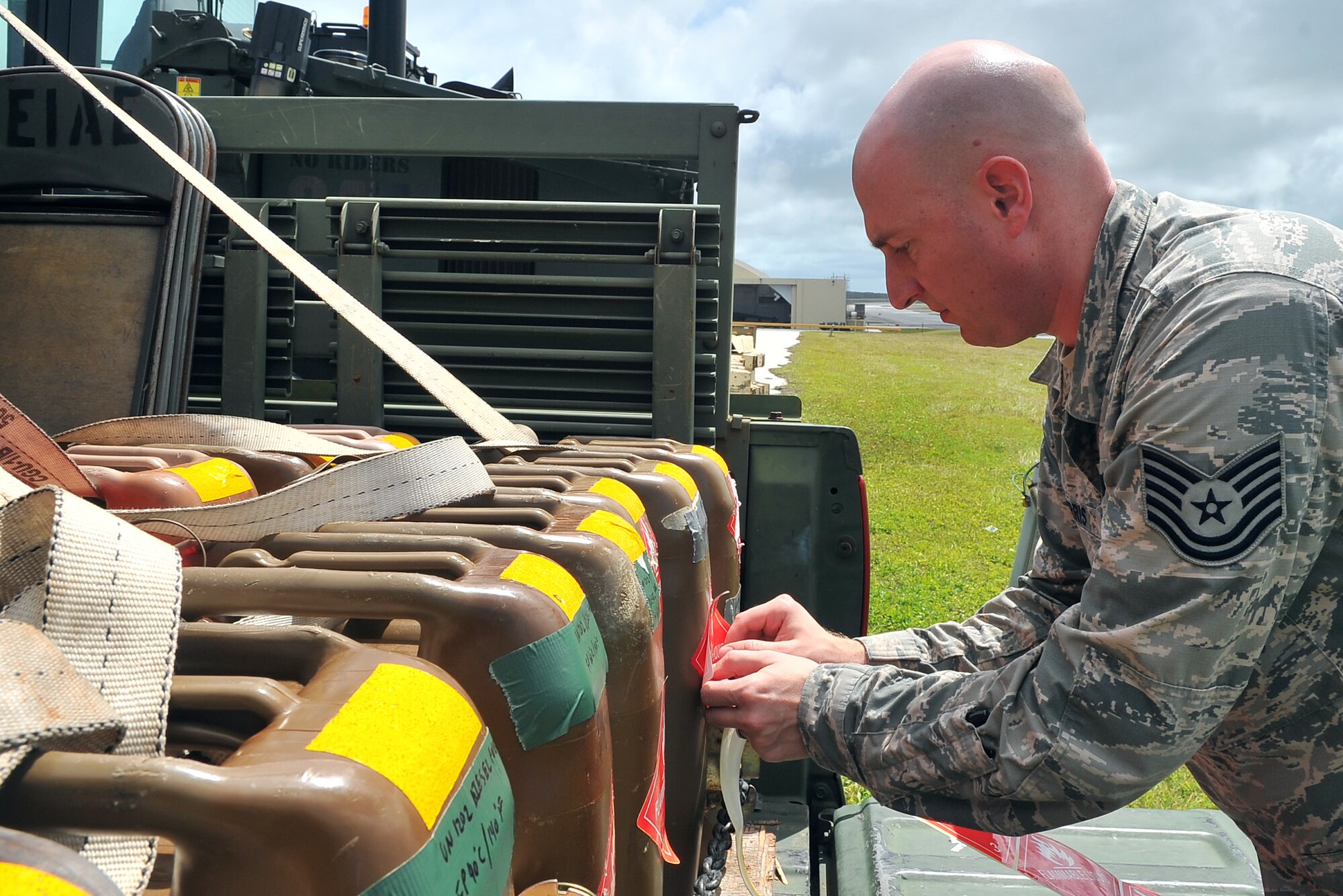 U.S. Air Force Tech. Sgt. Eric Morris, 36th Mobility Response Squadron ramp coordinator, labels fuel containers during cargo processing May 1, 2015, at Andersen Air Force Base, Guam, in preparation for deployment to Nepal. The 36th Contingency Response Group is a rapid-deployment unit designed to establish and maintain airfield operations and will join U.S. Department of State and U.S. Agency for International Development led humanitarian and disaster relief operations in support of the Government and Armed Forces of Nepal.  (U.S. Air Force photo by Staff Sgt. Melissa White/Released)