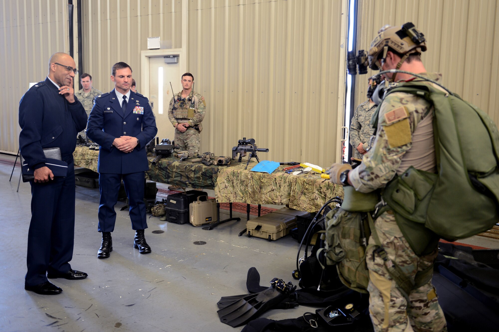 Brig. Gen. James Johnson (left), Air Force Recruiting Service commander, looks at equipment worn by Senior Airman Derek Brown, 22nd Special Tactics Squadron combat controller, May 7, 2015, at Joint Base Lewis-McChord, Wash. Airmen from the 22nd STS gave brief explanations of their equipment and the training they receive to become qualified. (U.S. Air Force photo/Airman 1st Class Keoni Chavarria)
