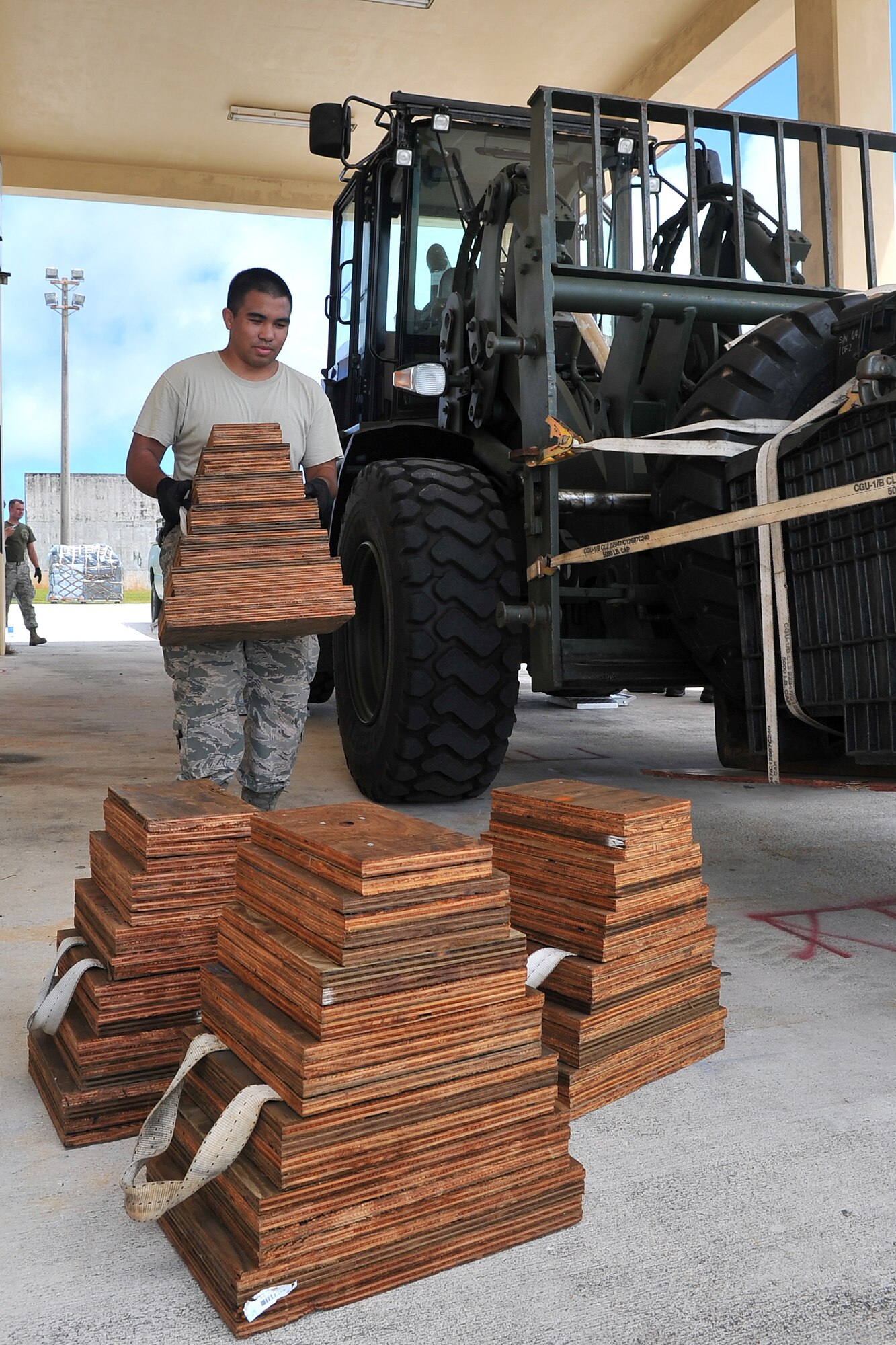 U.S. Air Force Senior Airman Jeremy Galindo, 36th Mobility response Squadron transportation specialist, moves shoring blocks, which are used to protect equipment and the aircraft during transport, May 1, 2015, at Andersen Air Force Base, Guam, in preparation for deployment to Nepal. The 36th Contingency Response Group is a rapid-deployment unit designed to establish and maintain airfield operations and will join U.S. Department of State and U.S. Agency for International Development led humanitarian and disaster relief operations in support of the Government and Armed Forces of Nepal.  (U.S. Air Force photo by Staff Sgt. Melissa White/Released)