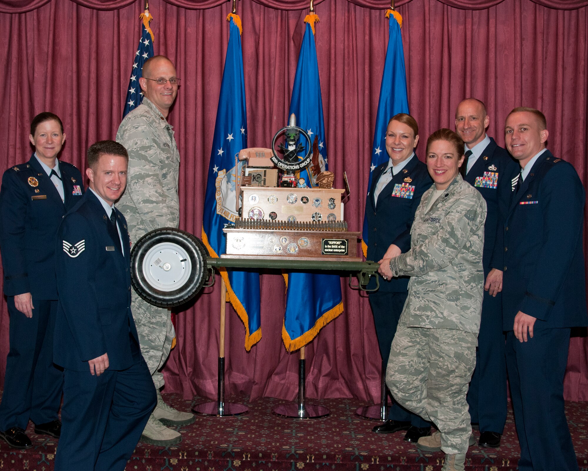 Airmen of the 90th Missile Wing Staff Agencies pose with Col. Tracey Hayes, 90th Missile Wing commander, and Chief Master Sgt. Samuel Couch, 90th MW command chief, while holding the 90th MW Spirit Award trophy at the 90th MW First Quarter Awards Breakfast, May 8, 2015, in the Trail’s End Club on F.E. Warren Air Force Base, Wyo. Wing staff won the 90th MW Spirit award, which is given by the wing commander to the organization that shows the greatest spirit at the quarterly awards breakfast. (U.S. Air Force photo by Senior Airman Jason Wiese)