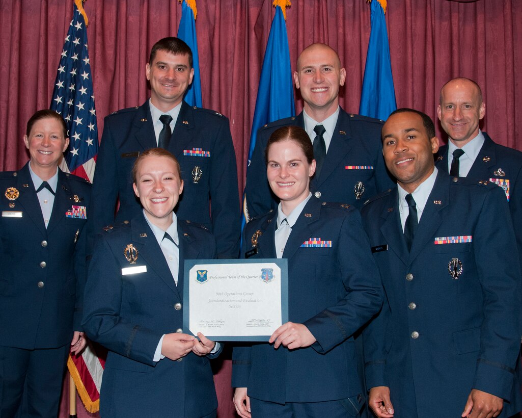 Airmen of the 90th Operations Group Standardization and Evaluation Section pose with Col. Tracey Hayes, 90th Missile Wing commander, and Chief Master Sgt. Samuel Couch, 90th MW command chief, at the wing’s first quarter awards breakfast, May 8, 2015, in the Trail’s End Club on F.E. Warren Air Force Base, Wyo. The Stan/Eval Section won Professional Team of the Quarter for the wing. (U.S. Air Force photo by Senior Airman Jason Wiese)