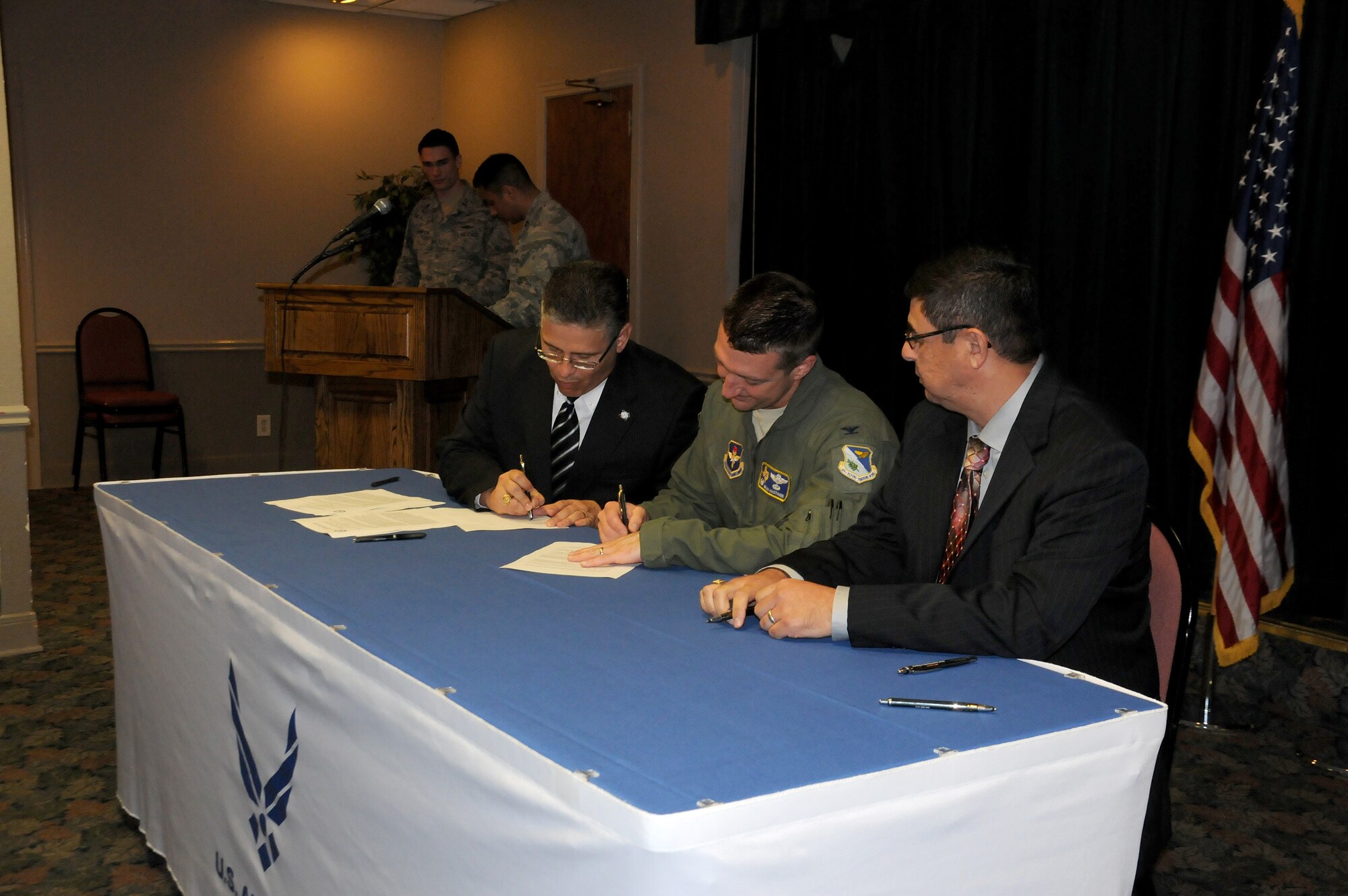 Col. Brian Hastings, 47th Flying Training Wing commander, signs a memorandum
of understanding with Dr. Carlos H. Rios, San Felipe-Del Rio Consolidated
Independent School District superintendent, left, and Dr. Hector Gonzales,
Southwest Texas Junior College president, at Club XL on Laughlin Air Force
Base, Texas, May 7, 2015. The memorandum between SWTJC and SFDR CISD built
upon the current "Grow Your Own Program" by developing an aircraft
maintenance certification as part of the school's Technical Certificates,
with classes to begin in the summer of 2015. (U.S. Air Force photo by 2nd
Lt. Jhanelle L. Haag)