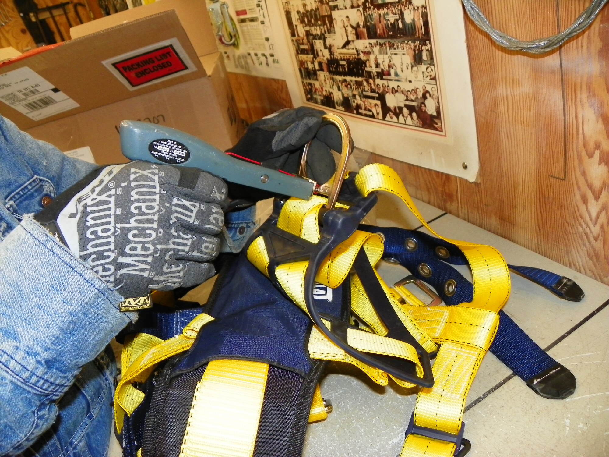 Fall Restraint competent person Jack Murdock tags a fall restraint harness with a wire tie to indicate it has passed inspection.