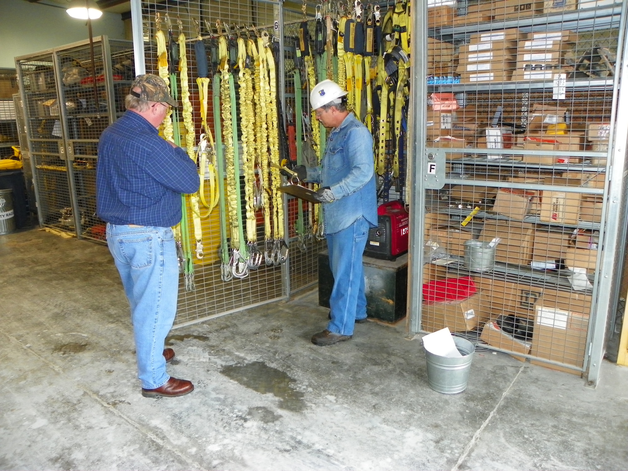Keith Sweeny, ATA Flight Systems Plant Assets Branch storekeeper, assists Jack Murdock, ATA Test Support Branch ironworker, in locating fall restraint devices for their annual inspection.
