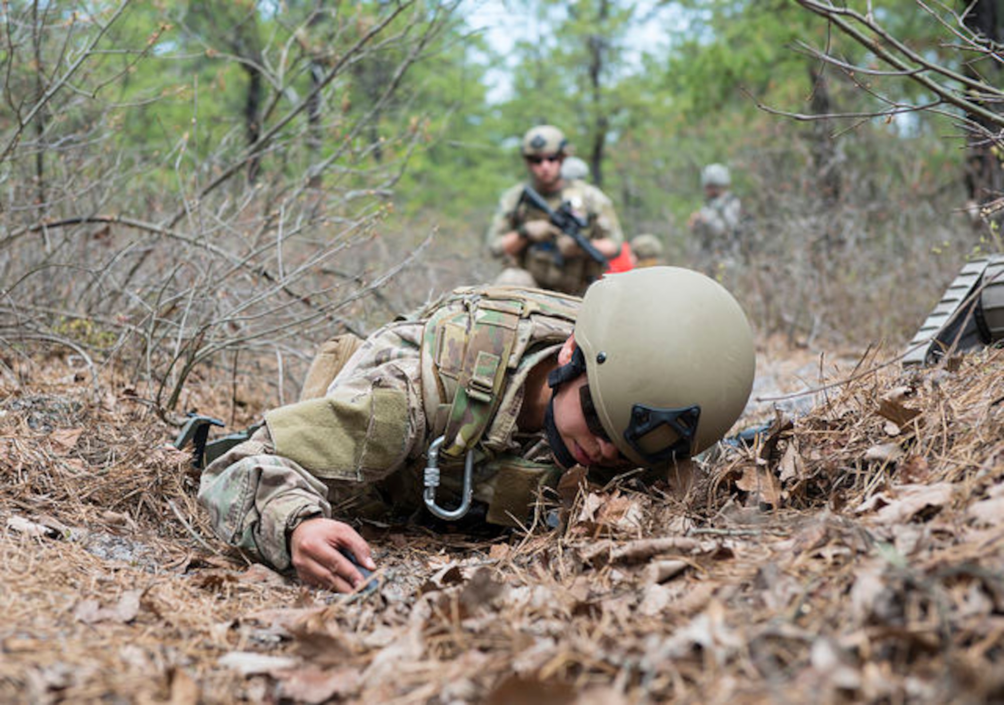 An Airman from the 87th Civil Engineer Squadron Explosive Ordinance Disposal team searches for an improvised explosive devise placed there for a field training exercise on Joint Base McGuire-Dix-Lakehurst, N.J. May 6, 2015. EOD replicated situations from Iraq and Afghanistan to take advantage of lessons learned there. (U.S. Air Force photo by Airman 1st Class Joshua King)