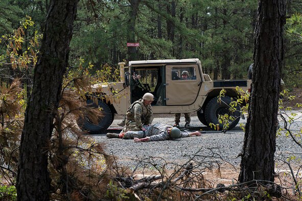 An Airman from the 87th Civil Engineer Squadron Explosive Ordnance Disposal team provides first aid to a simulated casualty during a field training exercise on Joint Base McGuire-Dix-Lakehurst, N.J. May 6, 2015. EOD replicated situations from Iraq and Afghanistan to take advantage of lessons learned there. (U.S. Air Force photo by Airman 1st Class Joshua King) 