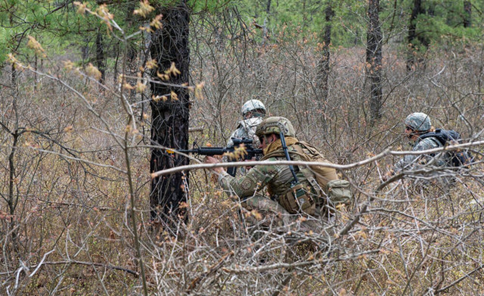 An Airman from the 87th Civil Engineer Squadron Explosive Ordinance Disposal team takes aim from behind cover during a field training exercise on Joint Base McGuire-Dix-Lakehurst, N.J. May 6, 2015. EOD replicated situations from Iraq and Afghanistan to take advantage of lessons learned there. (U.S. Air Force photo by Airman 1st Class Joshua King)