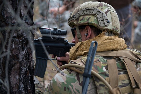 An Airman from the 87th Civil Engineer Squadron Explosive Ordnance Disposal team takes aim from behind cover during a field training exercise on Joint Base McGuire-Dix-Lakehurst, N.J. May 6, 2015. EOD replicated situations from Iraq and Afghanistan to take advantage of lessons learned there. (U.S. Air Force photo by Airman 1st Class Joshua King) 

