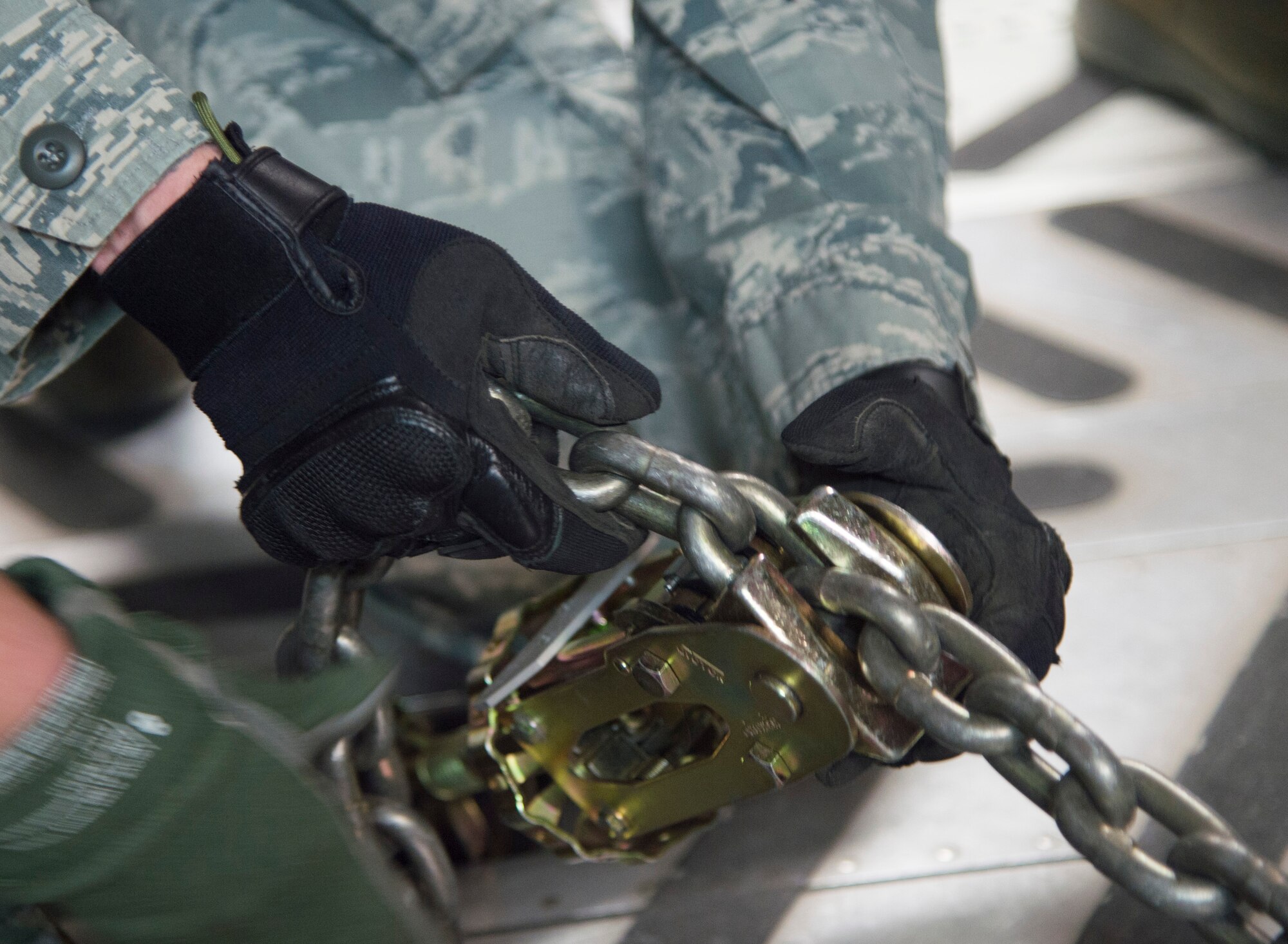 Airmen from the 621st Contingency Response Wing chain down equipment onto a U.S. Air Force Globemaster III C-17 during an exercise at Joint Base McGuire-Dix-Lakehurst, N.J., April 29. The exercise helped train the crew members from five C-17’s, conducted engine running offloads, communication proficiency training, night vision goggle training, and a ramp coordinator chief received upgraded training during this exercise. (U.S. Air Force photo/Staff Sgt. Gustavo Gonzalez)
