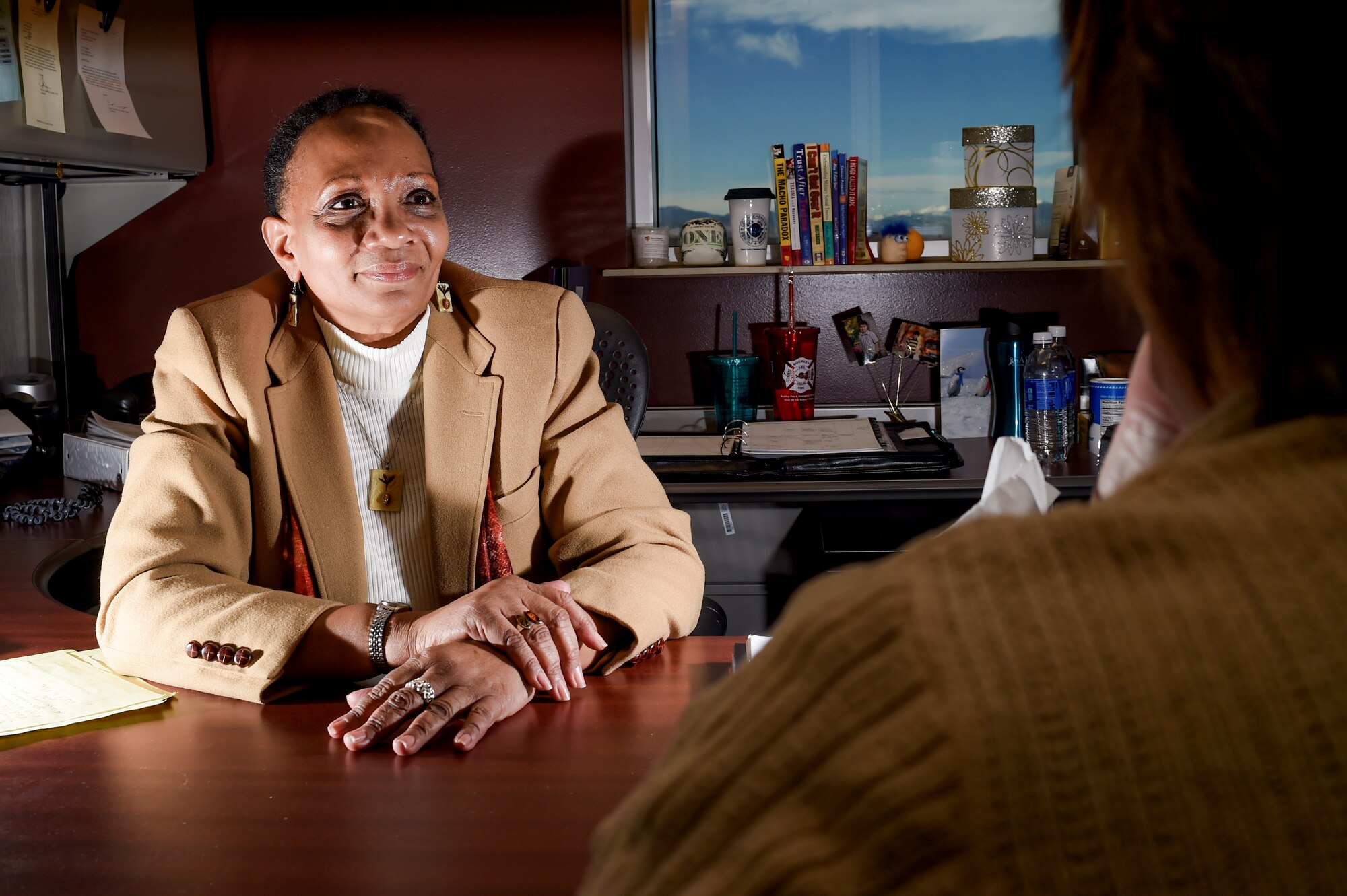 Peggy Moore-Mccoy, 460th Space Wing sexual assault response coordinator, speaks with Christine Saona, 460th SW victim advocate on 16 Jan., 2015, on Buckley Air Force Base, Colo. Moore-Mccoy has worked as a SARC since 2005, where she works to change stereotypes, increase awareness and work with victims of sexual assault. (U.S. Air Force photo by Senior Airman Phillip Houk/Released) 