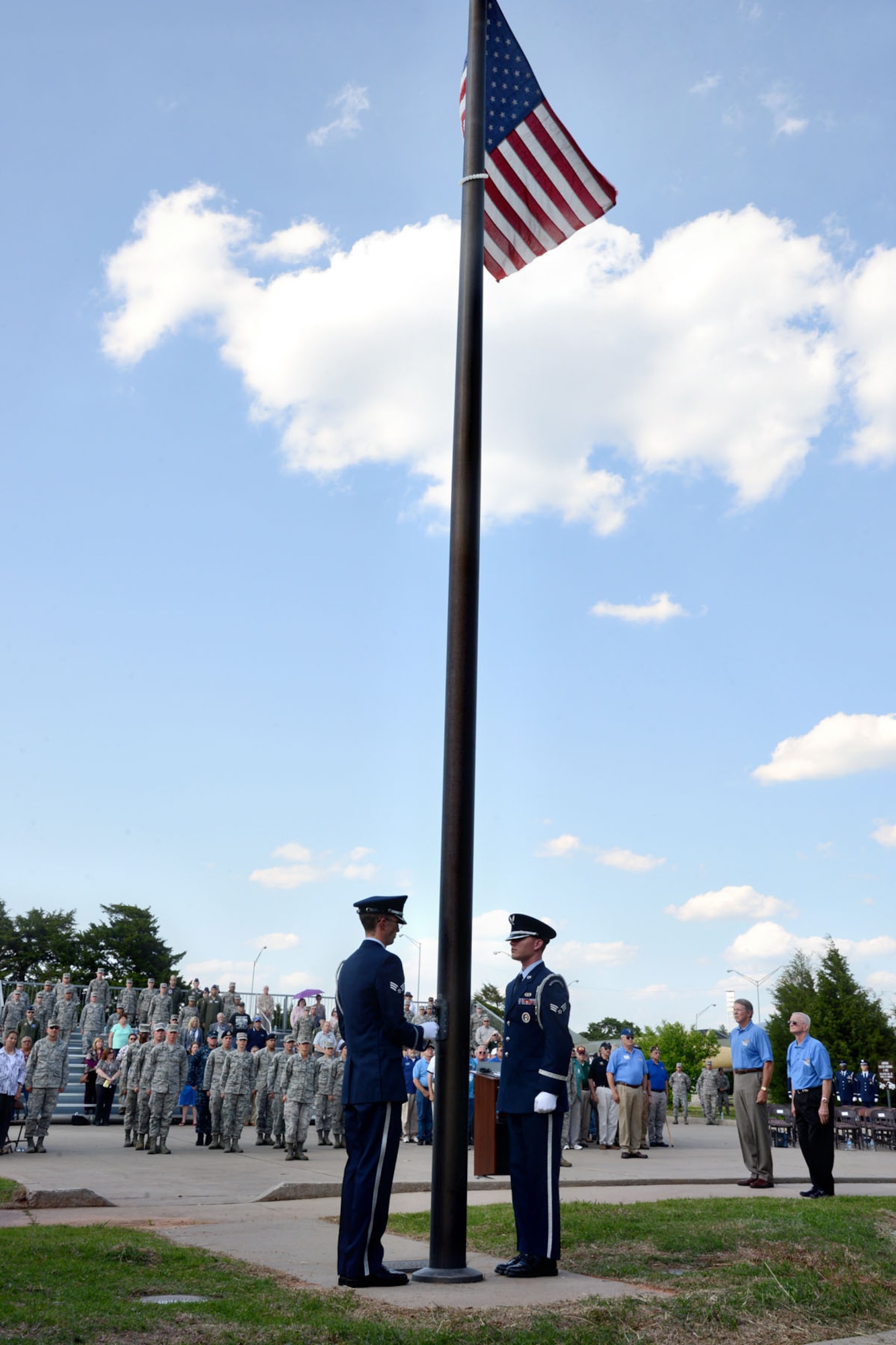 Tinker Honor Guard members lower the American Flag during the April 30 Back to Blue retreat ceremony in commemoration of the 40th anniversary of the end of the Vietnam War. Vietnam veterans and Tinker military members stood together in formation during the ceremony. (Air Force photo by Kelly White/Released)
