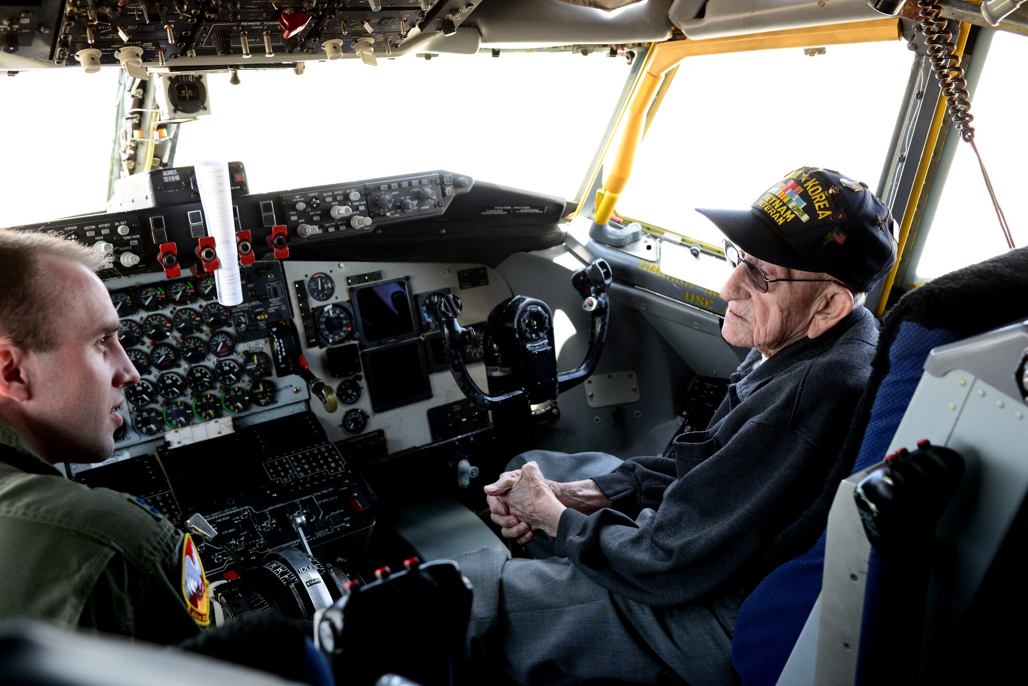 Capt. Jacob Allen, an executive officer for the 64th Air refueling Squadron, (left) talks with retired Chief Master Sgt. Albert Paine, a World War II, Korean and Vietnam War pilot, inside a New Hampshire Air National Guard KC-135, May 8, 2015 Pease Air National Guard Base, N.H. Paine visited to talk about his career as an enlisted pilot during three major wars. (N.H. Air National Guard photo by Airman Ashlyn J. Correia)