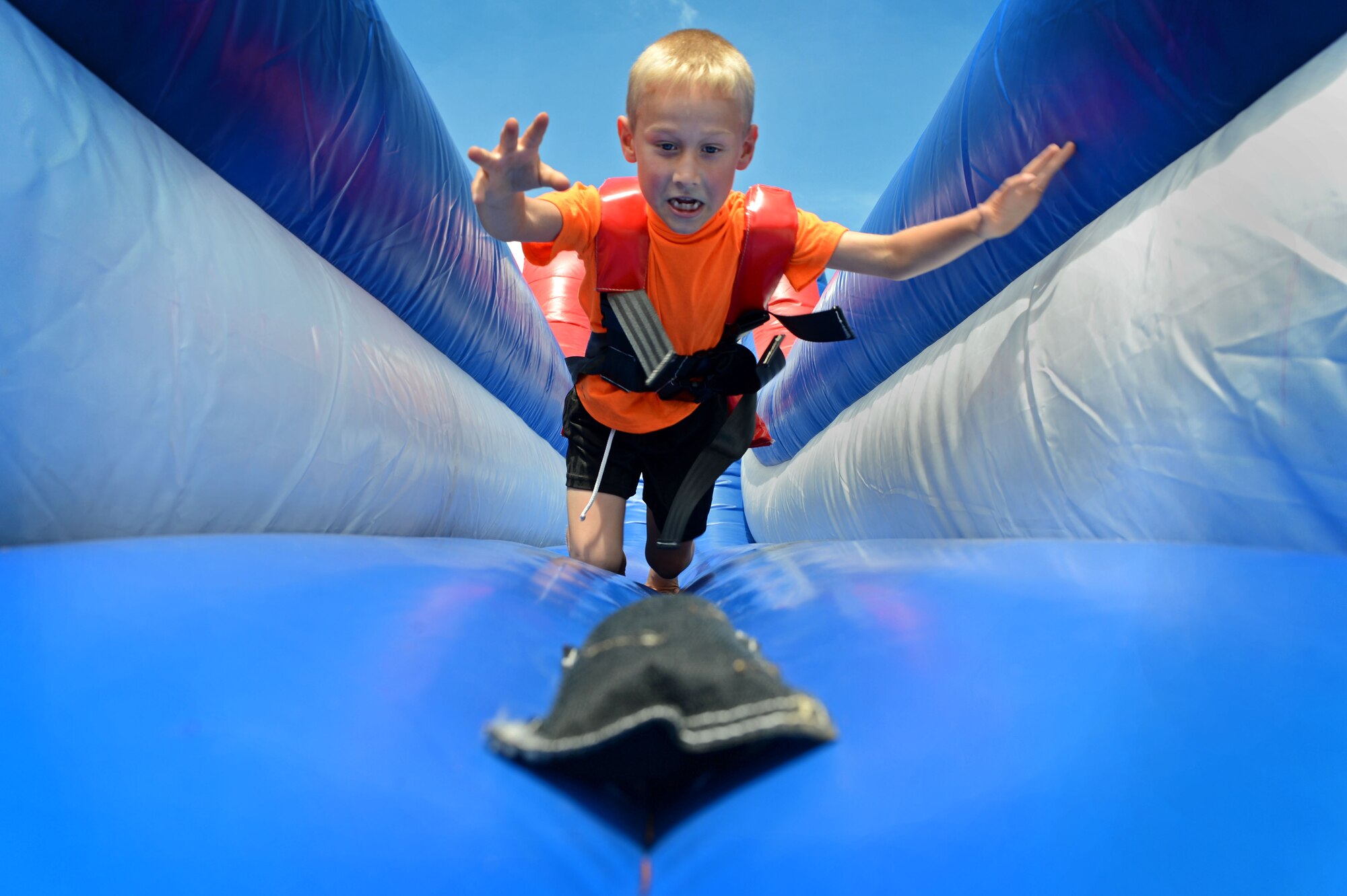 A child jumps for a bean bag during a “Big-A” game day at Shaw Air Force Base, S.C., May 8, 2015. Airmen were encouraged to bring their families to the event which was held to say “good-bye” to CMSgt Charles Mills, 20th Fighter Wing command chief as he prepares to make a permanent change of station. (U.S. Air force photo by Senior Airman Jensen Stidham/Released) 