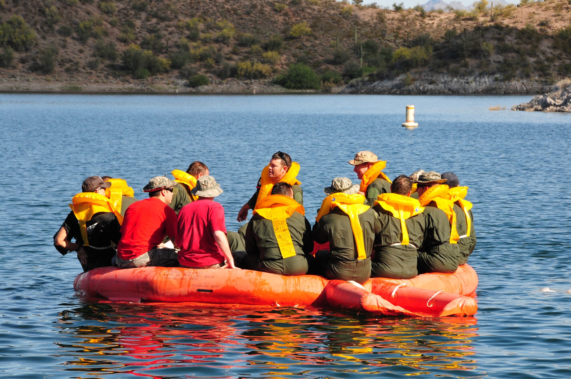 Airmen from the 161st Air Refueling Wing take accountability of personnel on a 20 man life raft during water survival training at Lake Pleasant, Peoria, Ariz., May 3, 2015.  Water survival training encompasses equipment familiarization and processes in the event of an emergency over-water ditching scenario.    (U.S. Air National Guard photo by Master Sgt. Kelly M. Deitloff)