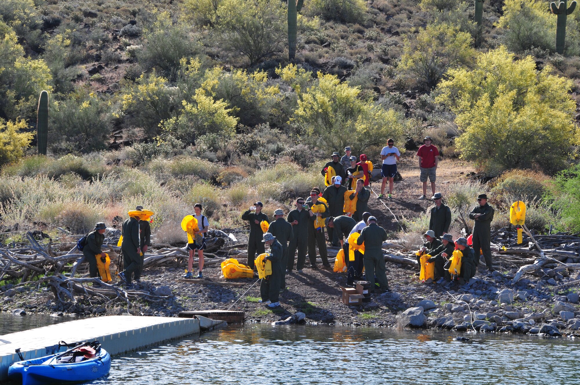 Airmen from the 161st Air Refueling Wing don their adult/child life preservers for water survival training at Lake Pleasant in Peoria, Ariz., May 3, 2015.  Water survival training encompasses equipment familiarization and processes in the event of an emergency over-water ditching scenario.    (U.S. Air National Guard photo by Master Sgt. Kelly M. Deitloff)