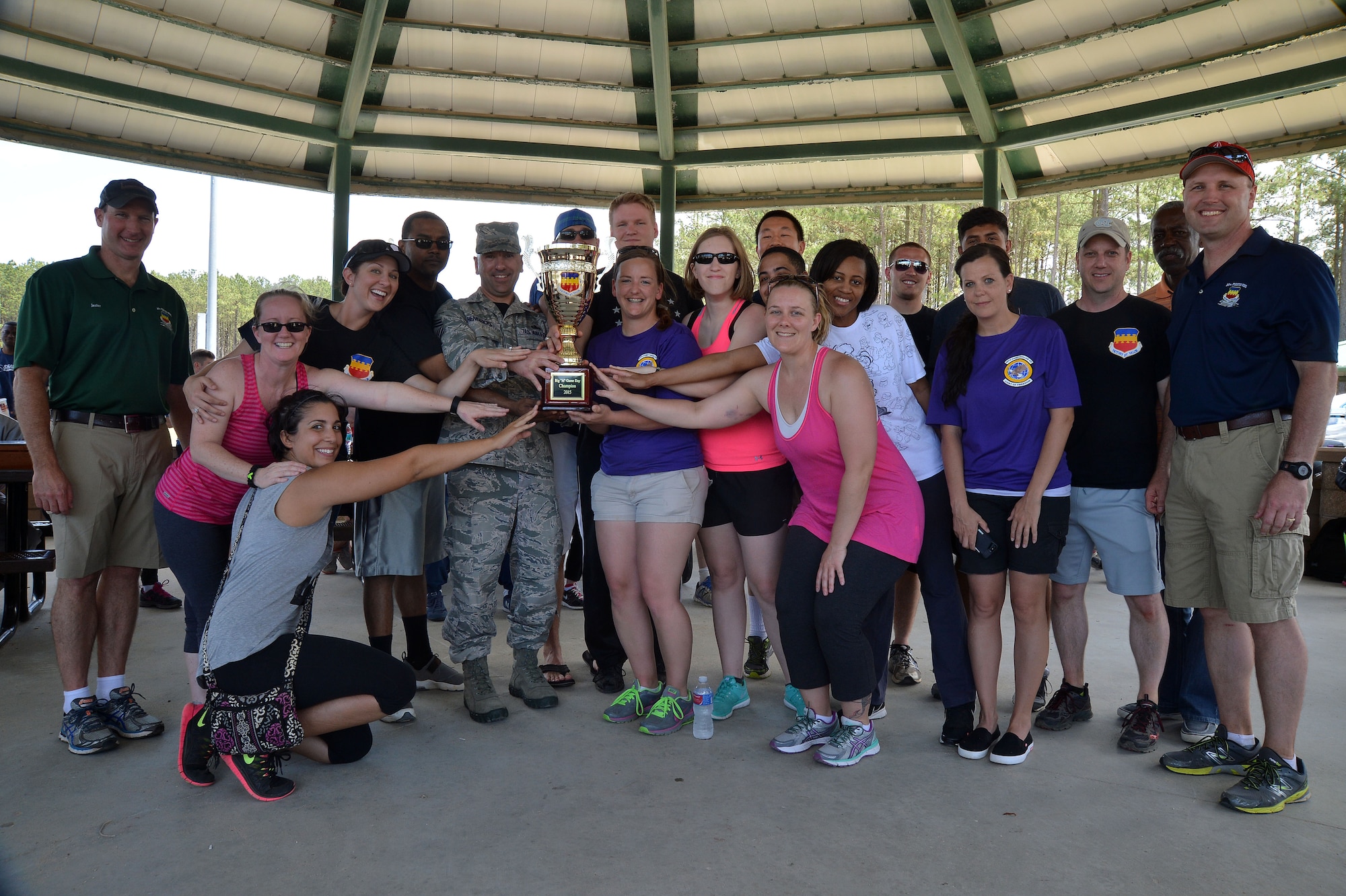 Airmen assigned to the Wing Staff Agencies hold the Big “A” Game Day challenge trophy at Shaw Air Force Base, S.C., May 8, 2015. The trophy was presented to the WSA Airmen for being the unit with the most involvement. (U.S. Air Force photo by Airman 1st Class Michael Cossaboom/Released)
