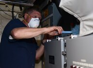 Kim Barnes, owner of a Great Falls cleaning company, dusts the top of an equipment rack of a launch control center at a missile alert facility near Malmstrom Air Force Base, Mont., May 4, 2015. Barnes and his son, Dustin, work together to deeply clean the LCC’s in the missile field in an effort to improve quality of life for the missileers who work in them. (U.S. Air Force photo/Airman 1st Class Dillon Johnston)